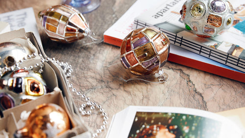 table with vintage style table cloth and Christmas ornaments