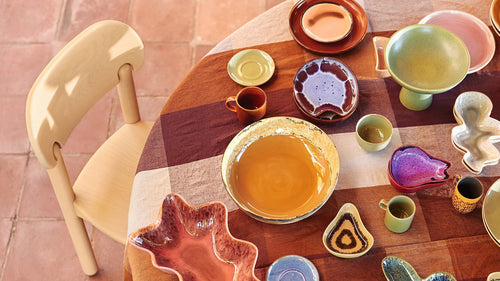 green bar kitchen island with retro style bowls, cups and cake plate