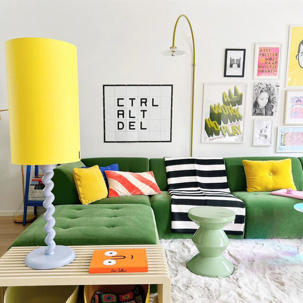 colorful living room with velvet green sofa and olive green accent table