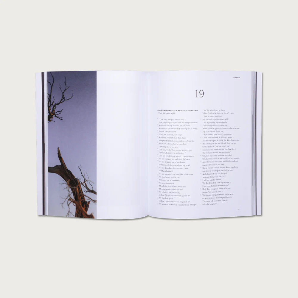 Open book with a page showing a tree silhouette and text on a white background