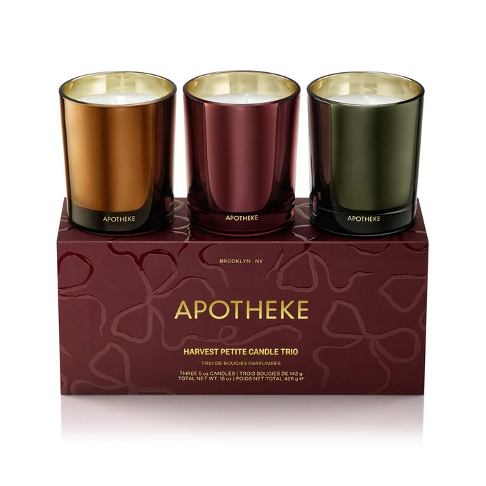 Three Apotheke candles in different colors on a matching box.