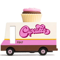 Toy truck with a cupcake on top and 'Cupcakes' written on it against a white background