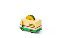 Toy taco truck with a taco on top on a white background