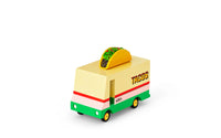 Toy taco truck with a taco on top against a white background