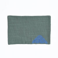 Green fabric pouch with blue cloud design on a white background
