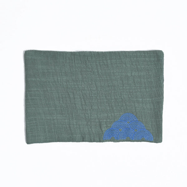Green fabric pouch with blue cloud design on a white background