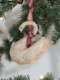 Decorative cotton ornament with pink ribbon on a Christmas tree