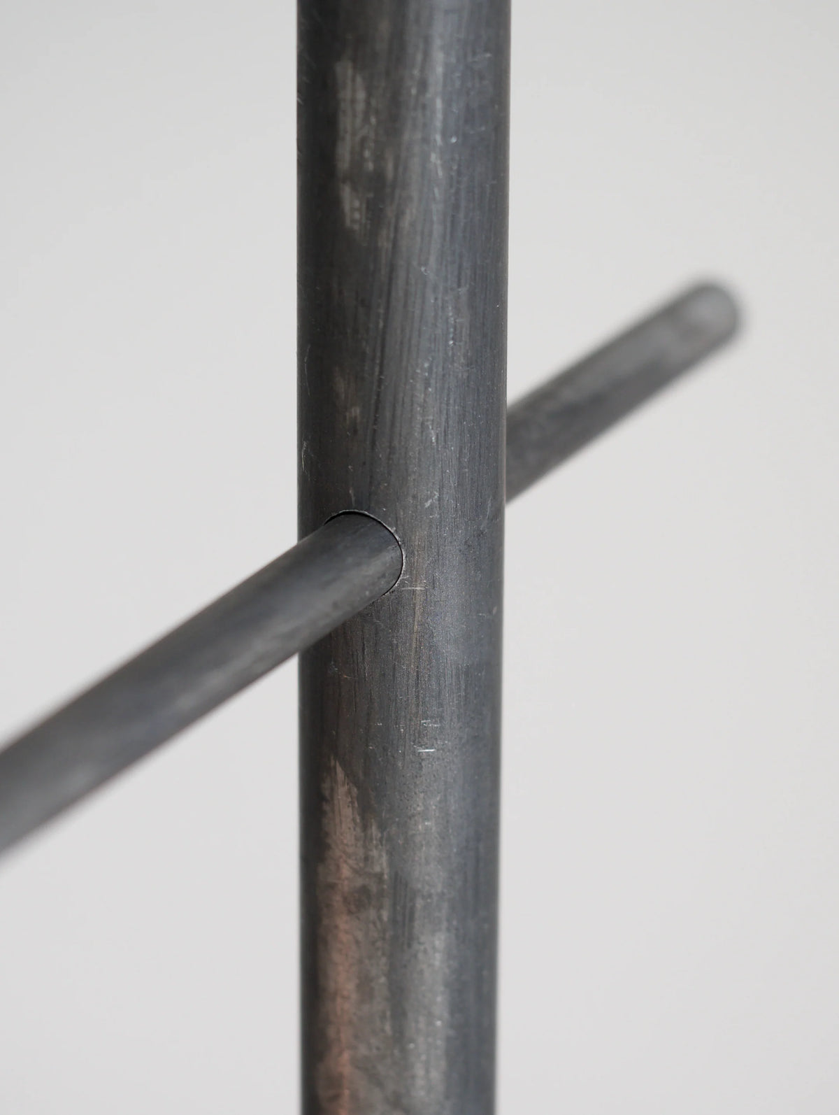 Close-up of a metal rod with a cylindrical cross-section on a white background