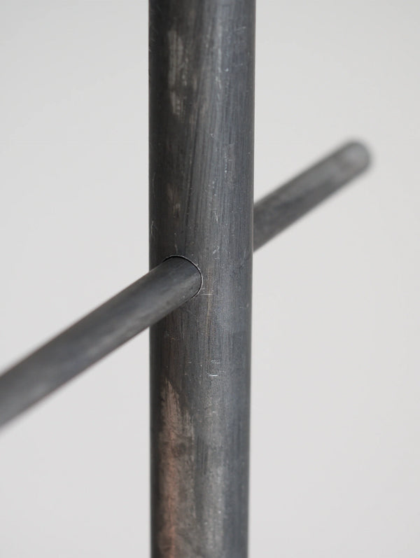 Close-up of a metal rod with a cylindrical cross-section on a white background