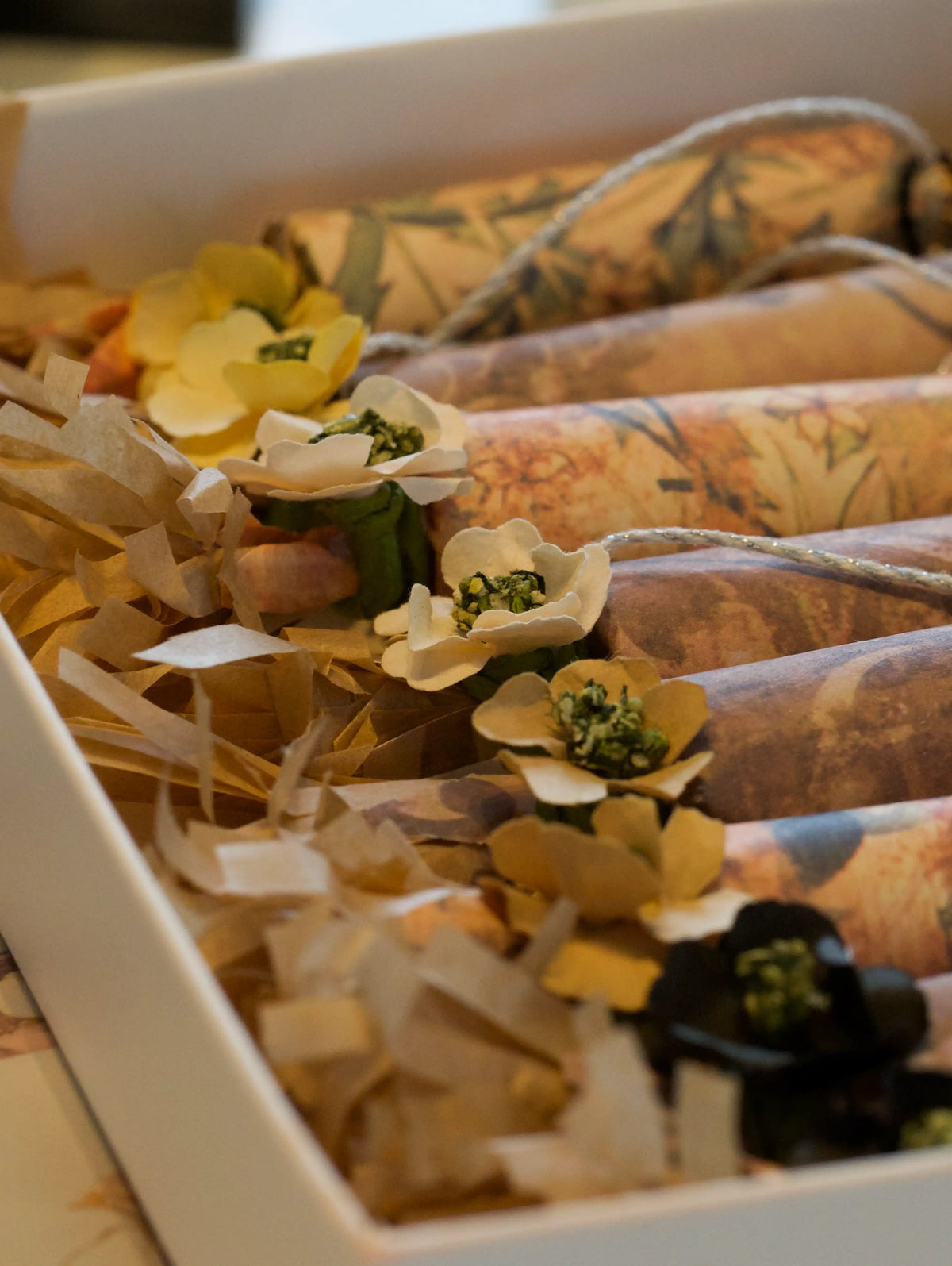 Decorative gift wrap with flowers and ribbons in a box