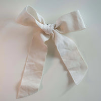 Light  Ivory white and pink bow on off white background