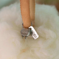 Close-up of a small mechanical component with a label on a white background