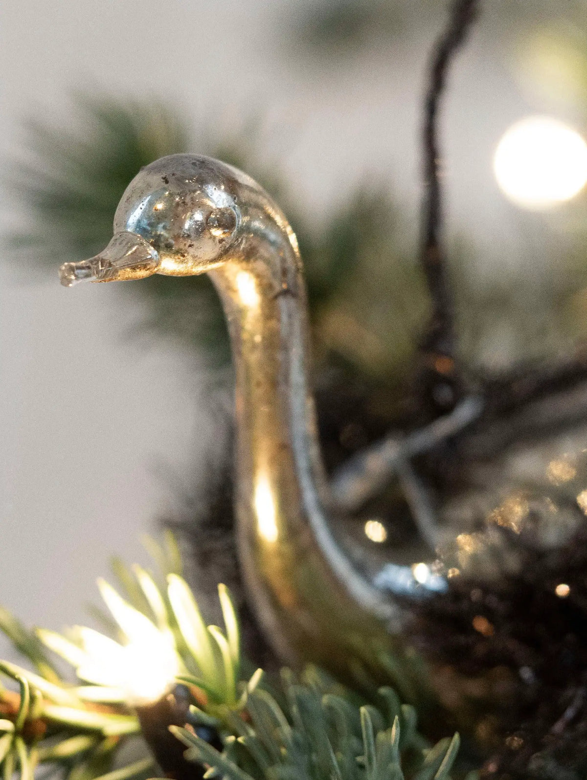 Decorative glass goose ornament on a Christmas tree