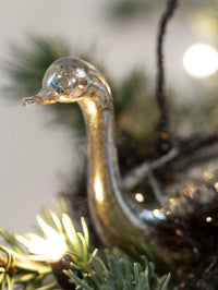 Decorative glass goose ornament on a Christmas tree