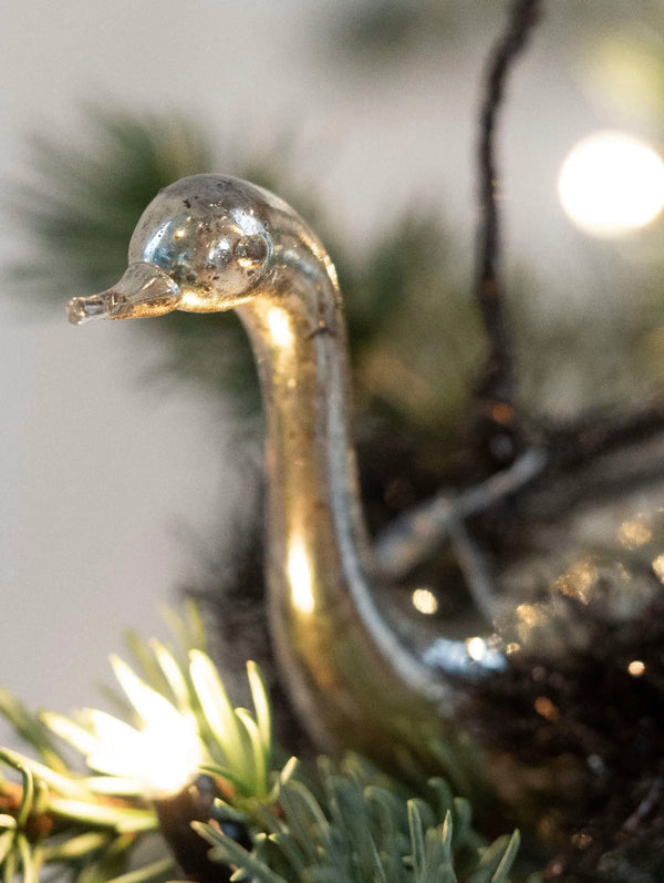 Decorative glass goose ornament on a Christmas tree