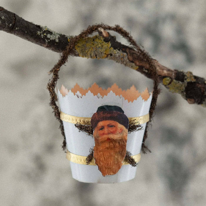 Decorative ornament with a n antique Santa Claus image  on a branch