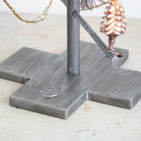 Metal stand with decorative elements on a light surface