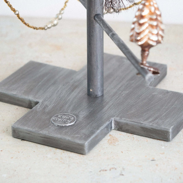 Metal stand with decorative elements on a light surface