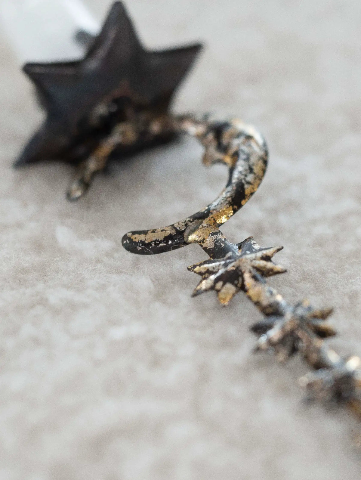 Metallic star-shaped ornament on a textured surface