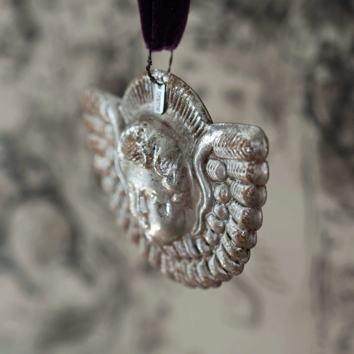 Silver decorative item on a blurred background