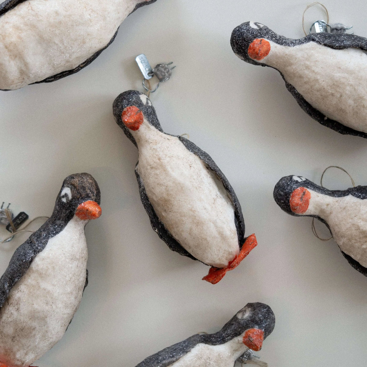Felt penguin ornaments on a white background