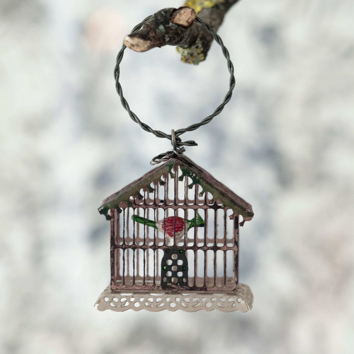 Decorative birdcage ornament with a rose on a blurred background