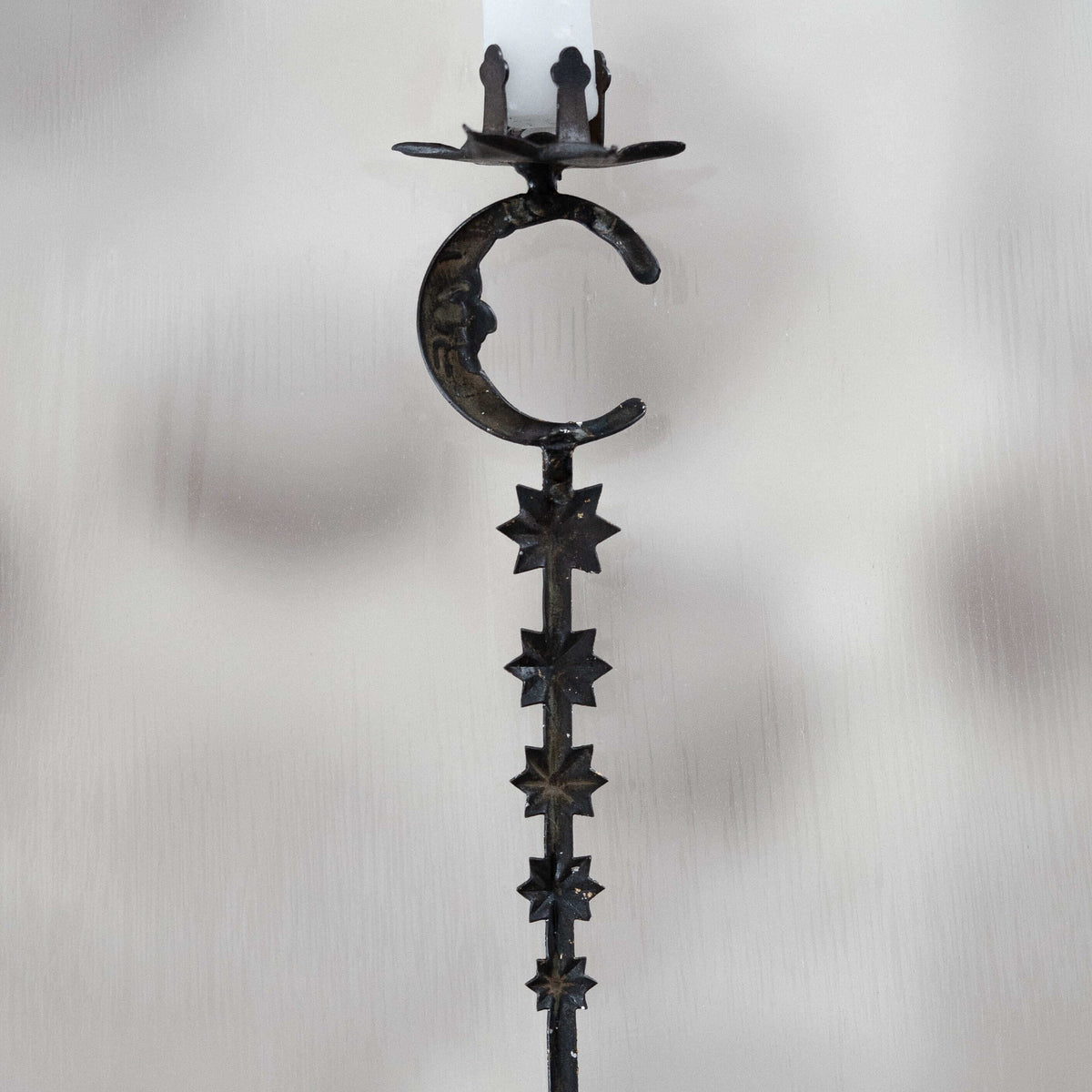 Decorative candle holder with star and moon design on a white background