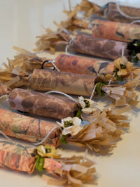 Decorative items with floral elements and patterned paper wrapping on a light background