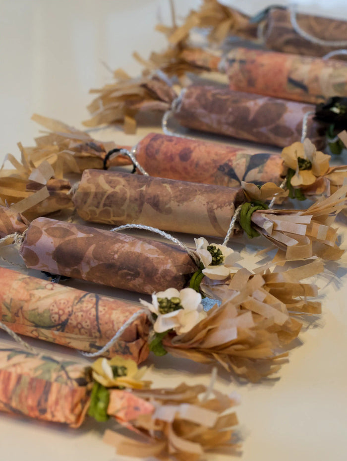 Decorative items with floral elements and patterned paper wrapping on a light background