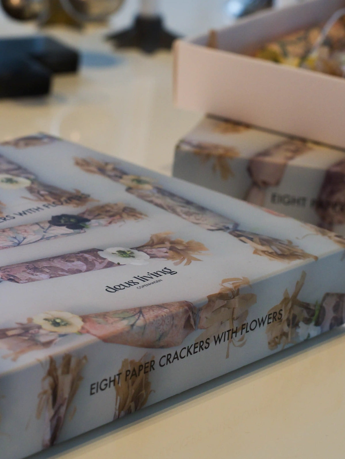 Box of paper crackers with floral design on a table