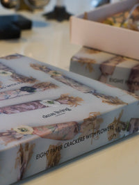 Box of paper crackers with floral design on a table