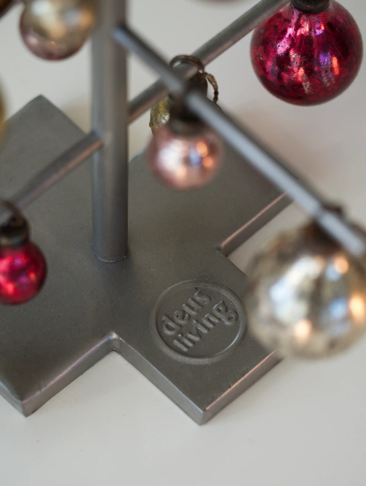 Decorative stand with colorful spherical ornaments on a light background