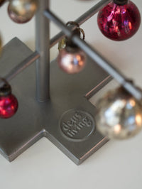 Decorative stand with colorful spherical ornaments on a light background
