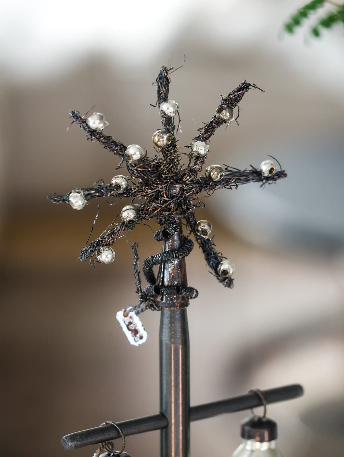 Decorative metal sculpture with intricate details on a blurred background