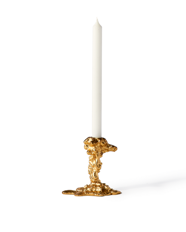 gold colored drip candle stick holder design object