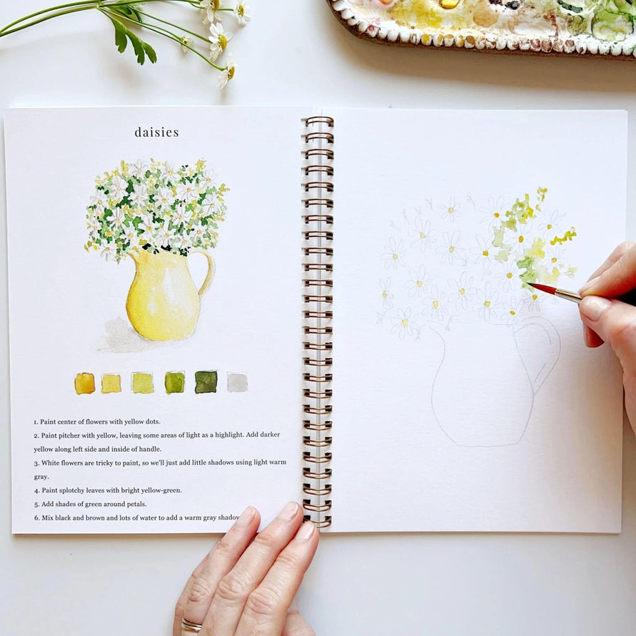 watercolor book with hand and painting