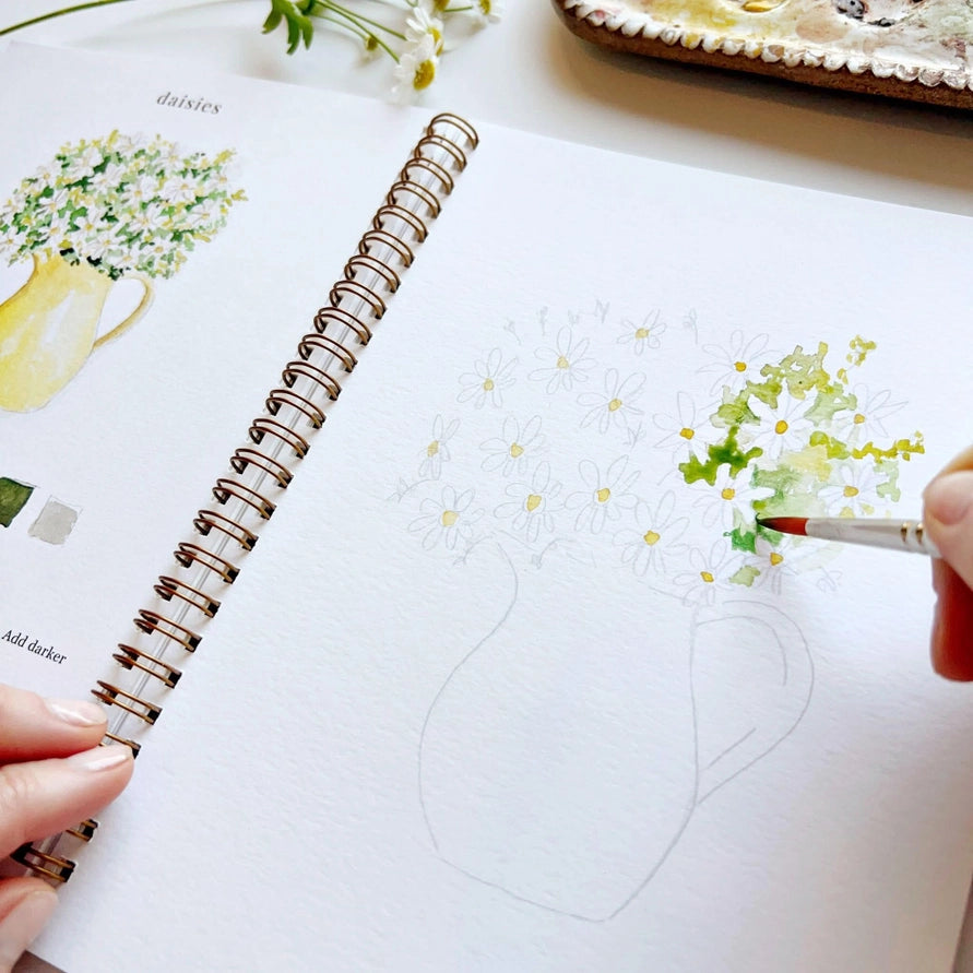watercolor book with hand and painting