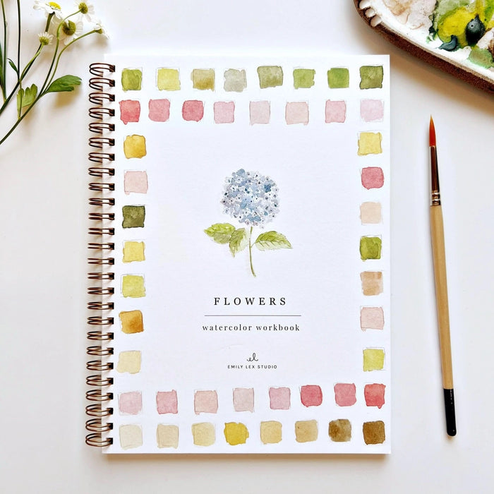 watercolor book with blue flower and brush