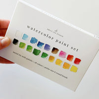 Watercolor paint set with color swatches on a white background