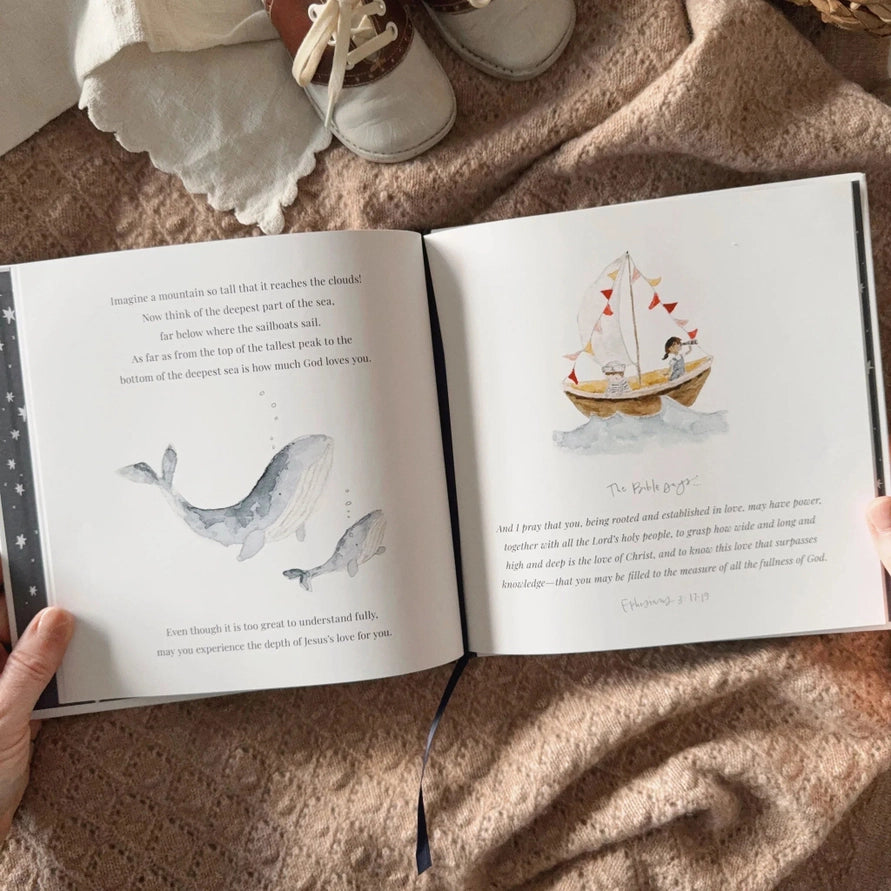 pages of a book with a hand a illustration of whales and a boot