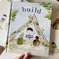 book with colorful cover of a boy sitting in a wooden tent structure