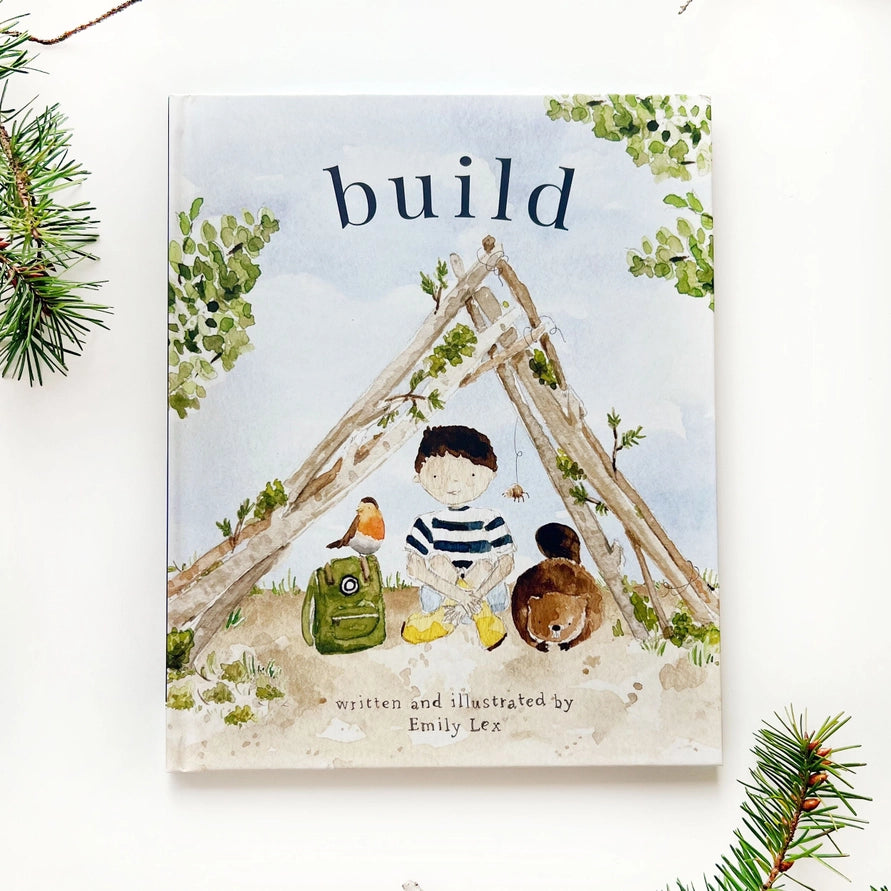book with colorful cover of a boy sitting in a wooden tent structure