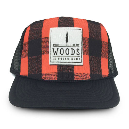 Black and red checkered cap with a patch that says 'Going to the woods is going home' on a white background.