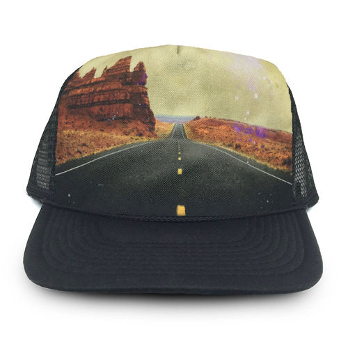Black trucker cap with desert landscape design on a white background