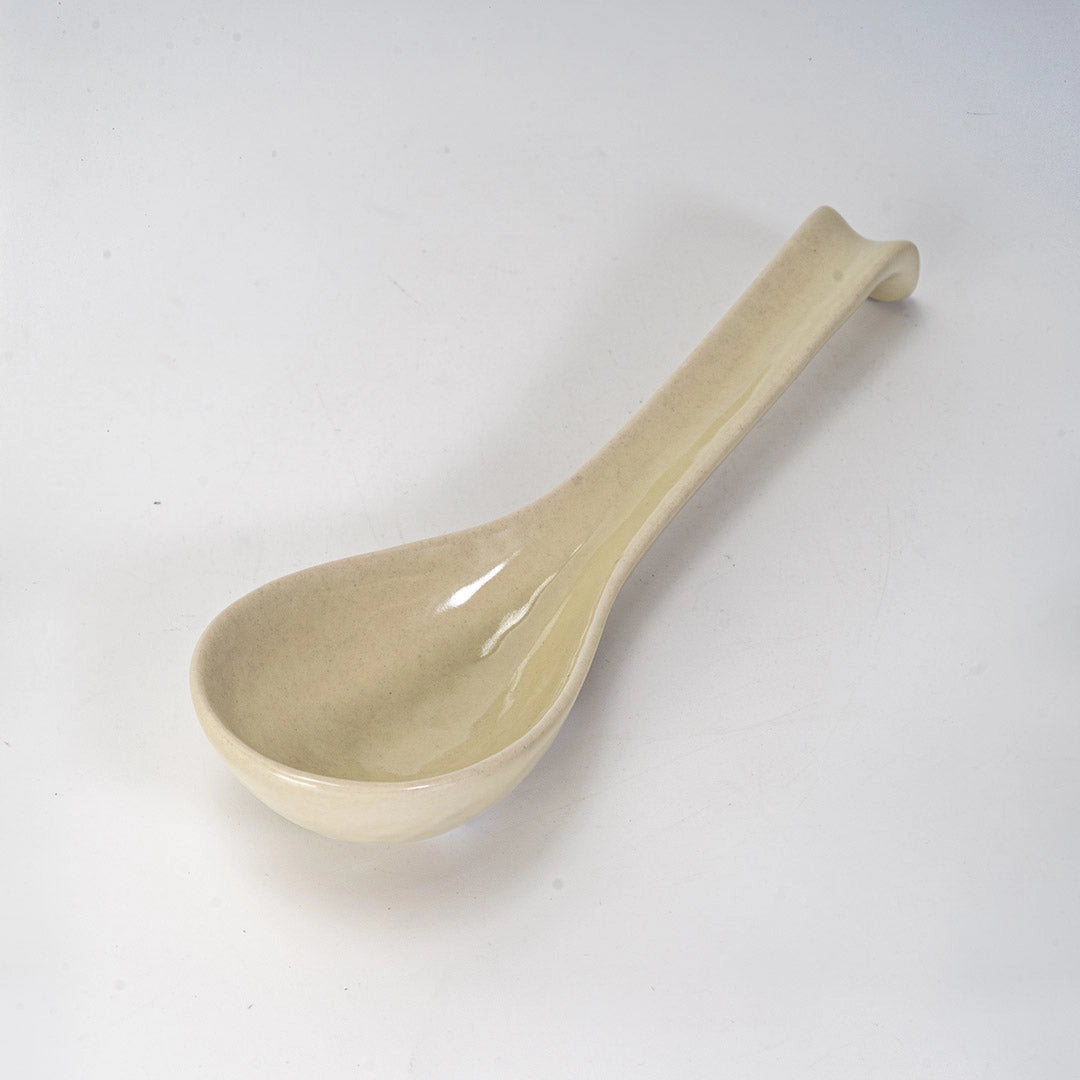 Beige ceramic spoon on a white background