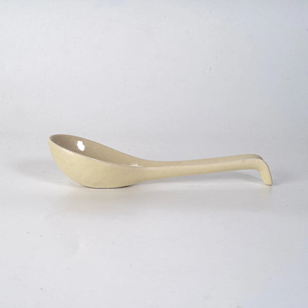 Beige ceramic ladle on a white background