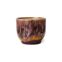 Ceramic cup with marbled design on a white background