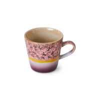 Ceramic mug with a gradient design from pink to purple on a white background