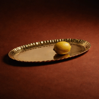 Gold tray with a lemon on a red background