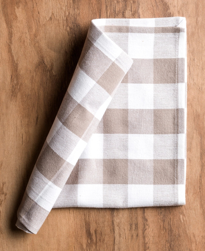 Folded checkered towel on a wooden surface